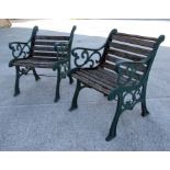 A pair of cast iron and wooden slatted garden chairs (2).
