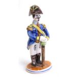 A Quimper faience style figure depicting a military gentleman, 19cms (7.5ins) high.