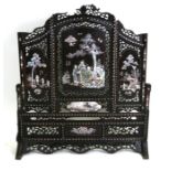 A Chinese hardwood screen with mother of pearl inlaid panels decorated with figures within