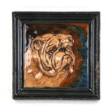 An early 20th century glazed pottery tile / wall plaque in relief of a British bulldog, the