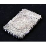 A Victorian silver card case of shaped rectangular form with chased decoration and central cartouche