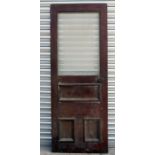 A mahogany panelled pub door with etched frosted glass panel, 75cms (29.5ins) wide.