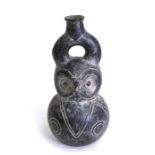 A South American pottery vase in the form of a stylised owl, 25cms (9.75ins) high.