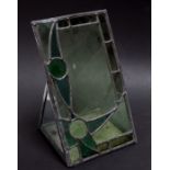 A leaded glass panel, mounted upright with mirrored base. 24 by 41cm ( 9.5 by 16 ins)