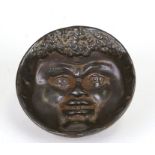 A heavy mixed metalware bowl, the inside formed as a mischievous face, 10.75 cms (4.25 ins)