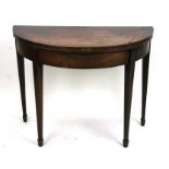 A 19th century mahogany demi-lune card table on square tapering legs with spade feet, 91cms (35.