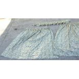 A pair of lined curtains with green leaf design, 104ins width by 88ins drop, ungathered.