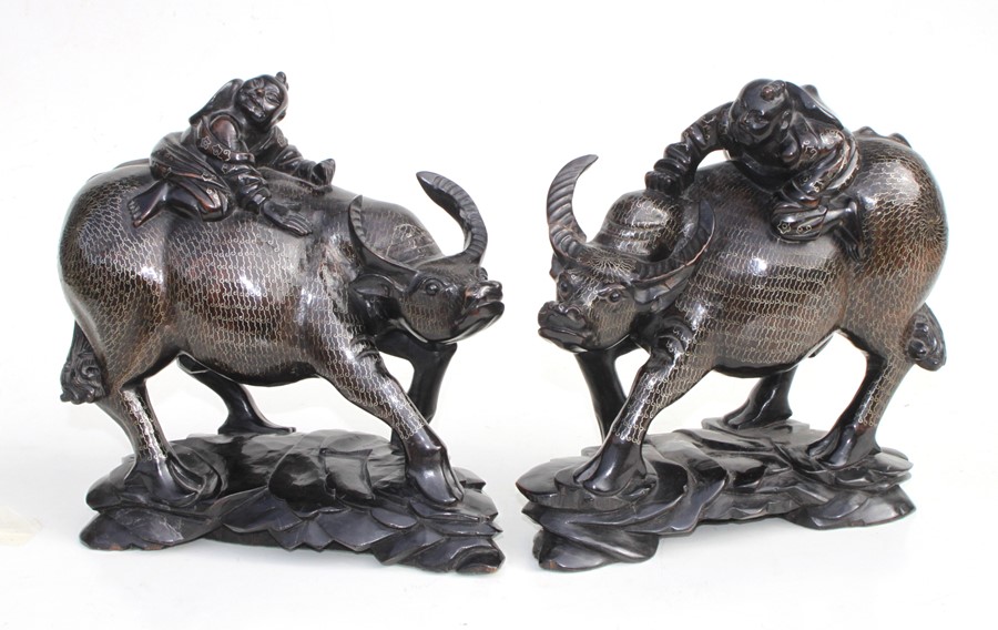 A pair of Chinese hardwood groups depicting children riding water buffalos, profusely inlaid with - Image 2 of 2