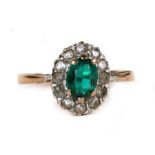 A 9ct gold cluster dress ring set with a central oval green stone, approx UK size 'O'.Condition