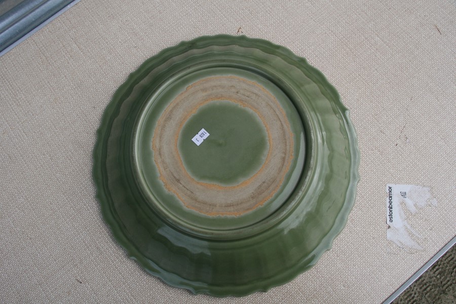 A large Chinese celadon glaze shallow bowl with incised decoration, 40cms (15.75ins) diameter. - Image 2 of 4