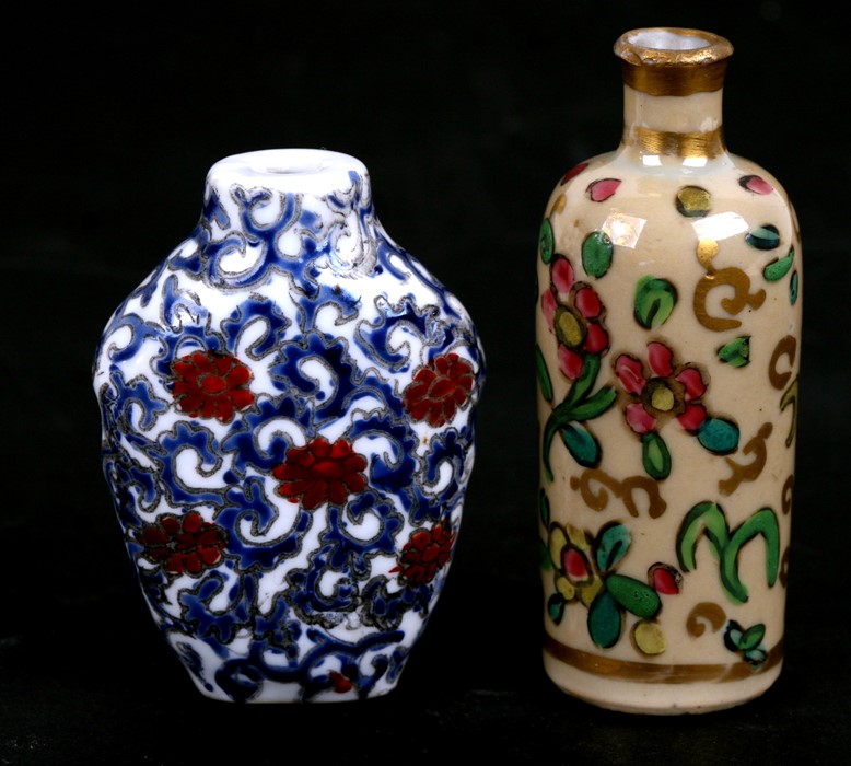 Two Chinese porcelain snuff bottles decorated with foliage, the largest 7.5cms (3ins) high (2).