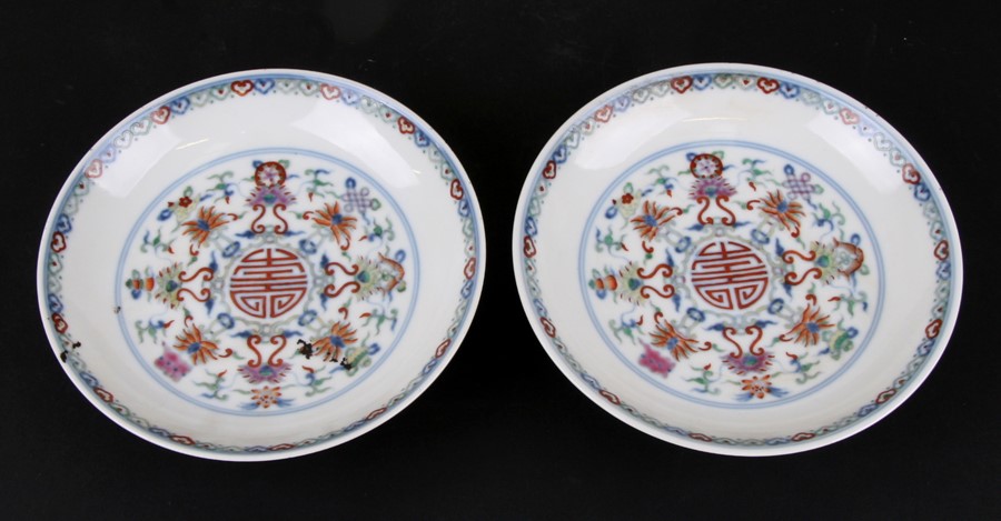 A pair of Chinese shallow dishes decorated with foliate scrolls, blue seal mark to the underside,