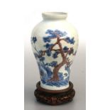 A Chinese blue & copper red baluster vase decorated with landscape scene, six character mark to