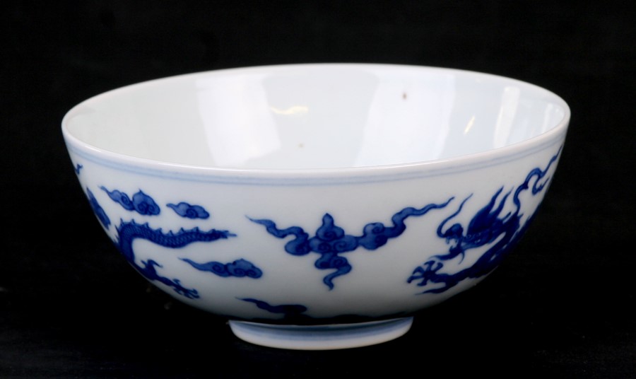 A 19th century Chinese blue & white bowl decorated with dragons amongst clouds, Qianlong seal mark