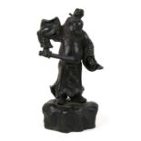 A Japanese bronze figure in the form of a warrior holding a sword, on a rocky base, 33cms (13ins)