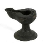 An early Islamic / Persian bronze oil lamp with engraved Arabic script, 9cms (3.5ins) high.