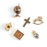 Six 9ct gold charm bracelet charms to include a Cuckoo clock, a rocking horse and a terrestrial