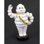 A reproduction cast iron Michelin man, 23cms (9ins) high.