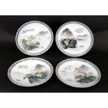 A set of four Chinese Republic style plates decorated with river landscape scenes and calligraphy,