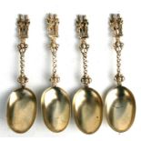 A set of four Dutch style gilt metal marriage spoons with figural finials, 18.5cms (7.25ins) long (
