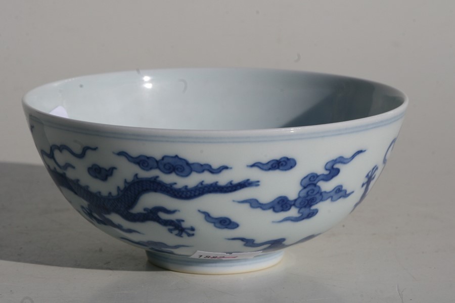 A 19th century Chinese blue & white bowl decorated with dragons amongst clouds, Qianlong seal mark - Image 7 of 11