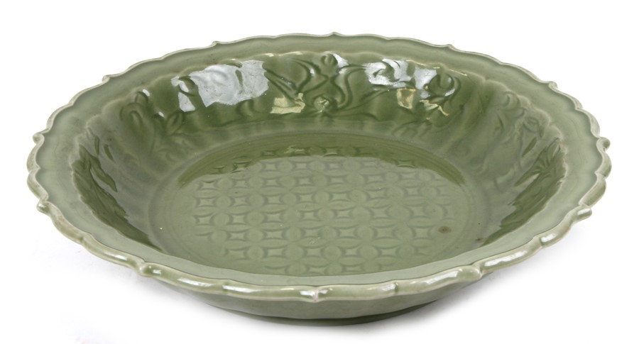 A large Chinese celadon glaze shallow bowl with incised decoration, 40cms (15.75ins) diameter.
