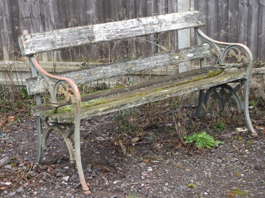 A cast iron and wooden slatted garden bench, 136cms (53.5ins) wide.