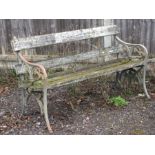 A cast iron and wooden slatted garden bench, 136cms (53.5ins) wide.