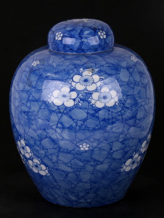 A large Oriental ginger jar decorated with prunus on a cracked ice ground, 28cms (11ins) high.