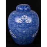 A large Oriental ginger jar decorated with prunus on a cracked ice ground, 28cms (11ins) high.
