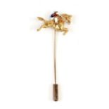 A yellow metal and enamel horse and jockey stick cravat pin, weight 4.3g.Condition Report Soldered