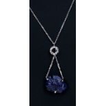 An 18ct white gold necklace with carved sapphire fish and diamond pendant.