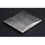 A silver cigarette case of shaped rectangular form with engine turned decoration, London 1931,