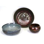 A Studio Pottery bowl, 18cms (7ins) diameter; together with two similar dishes, 26cms (10.25ins) and