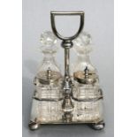 A Victorian four-piece silver and cut glass cruet set, the rectangular frame having a stirrup