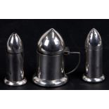 A George V silver novelty cruet set in the form of bullets or shells, retailed by Daniel Todd & Son,