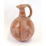 A Cypriot Redware jug of ovoid form, 14cms (5.5ins) high (a/f).