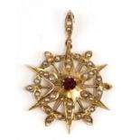 A late 19th / early 20th century 9ct gold amethyst and seed pearl star burst pendant, 4cms 1.5ins)