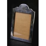 A silver shaped rectangular strut photo frame, Sheffield 1912, 16cms (6.25ins) wide.