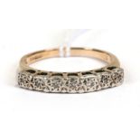 A 9ct gold seven-stone illusion set diamond ring, approx UK size 'Q'.