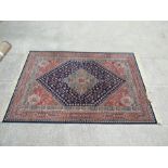 A large pair of modern Persian rugs with central medallion on a blue ground, 290 by 200cms (114 by
