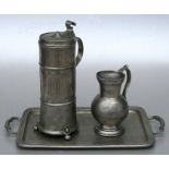 A French two-handled pewter tray, 39cms (15.75ins) wide; together with a pewter jug, 15cms (6ins)