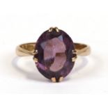 A 9ct gold ring set with an oval amethyst, approx UK size 'M'.