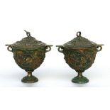 A pair of Grand Tour style lidded two-handled urns decorated with scrolling grape and vine, 15.