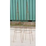 A pair of metal plant supports, obelisks of tapering form, 196cms (77ins) high.