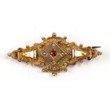 A Victorian 9ct gold ruby and seed pearl set mourning brooch, 5cms (2ins) wide.