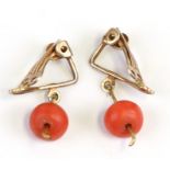 A pair of coral drop clip-on earrings.
