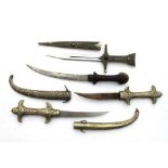 Four assorted Arabian, Indian and Eastern daggers. The longest blade being 24.5cms (9.75ins)