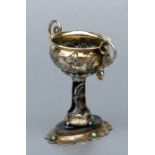 A Continental gilded white metal two-handled pedestal bowl with turquoise cabochons on an agate