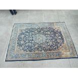 A Persian rug with central medallion with foliate scrolls on a blue ground, 192 by 284cms (75.5 by